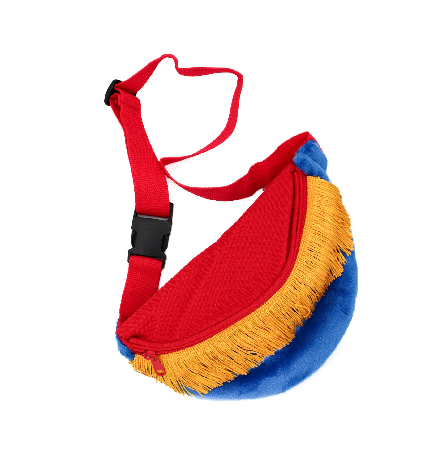 The Fringe Fanny Pack - Yellow features a red main section, fluffy faux fur blue trim, and yellow fringe at the bottom. It includes a red adjustable strap with a black buckle. This colorful crescent-shaped crossbody bag is set against a white background, blending style and function perfectly.