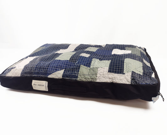 Large patchwork cushion in blue, black and grey.