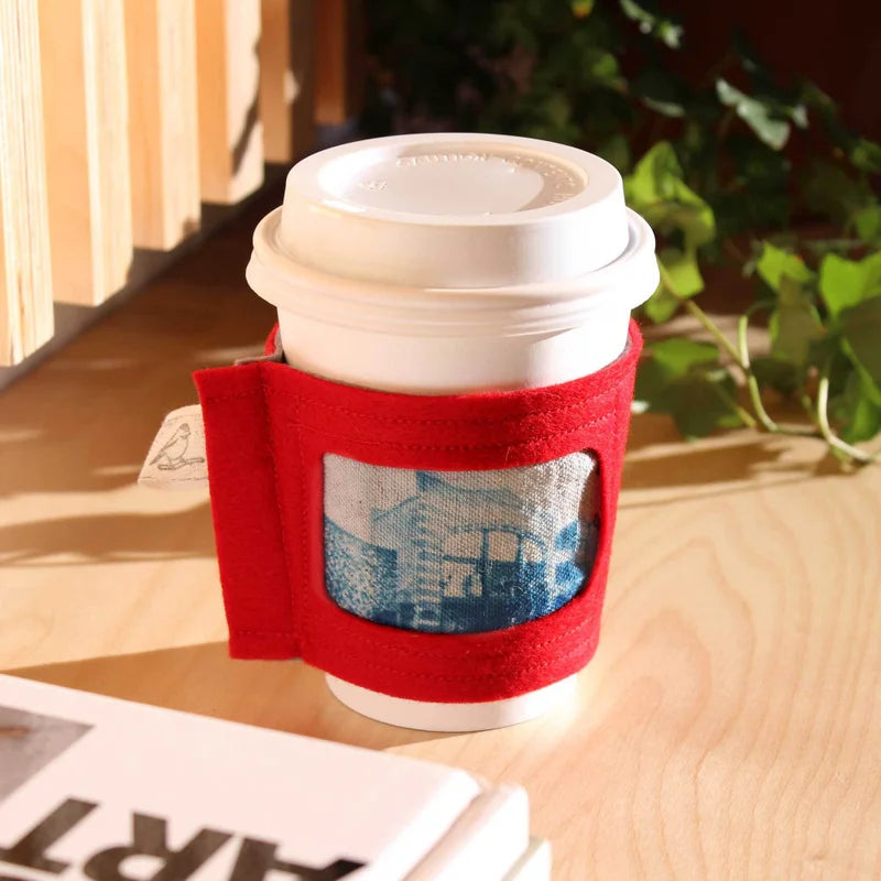 red and grey wool coffee sleeve with printed image of the building